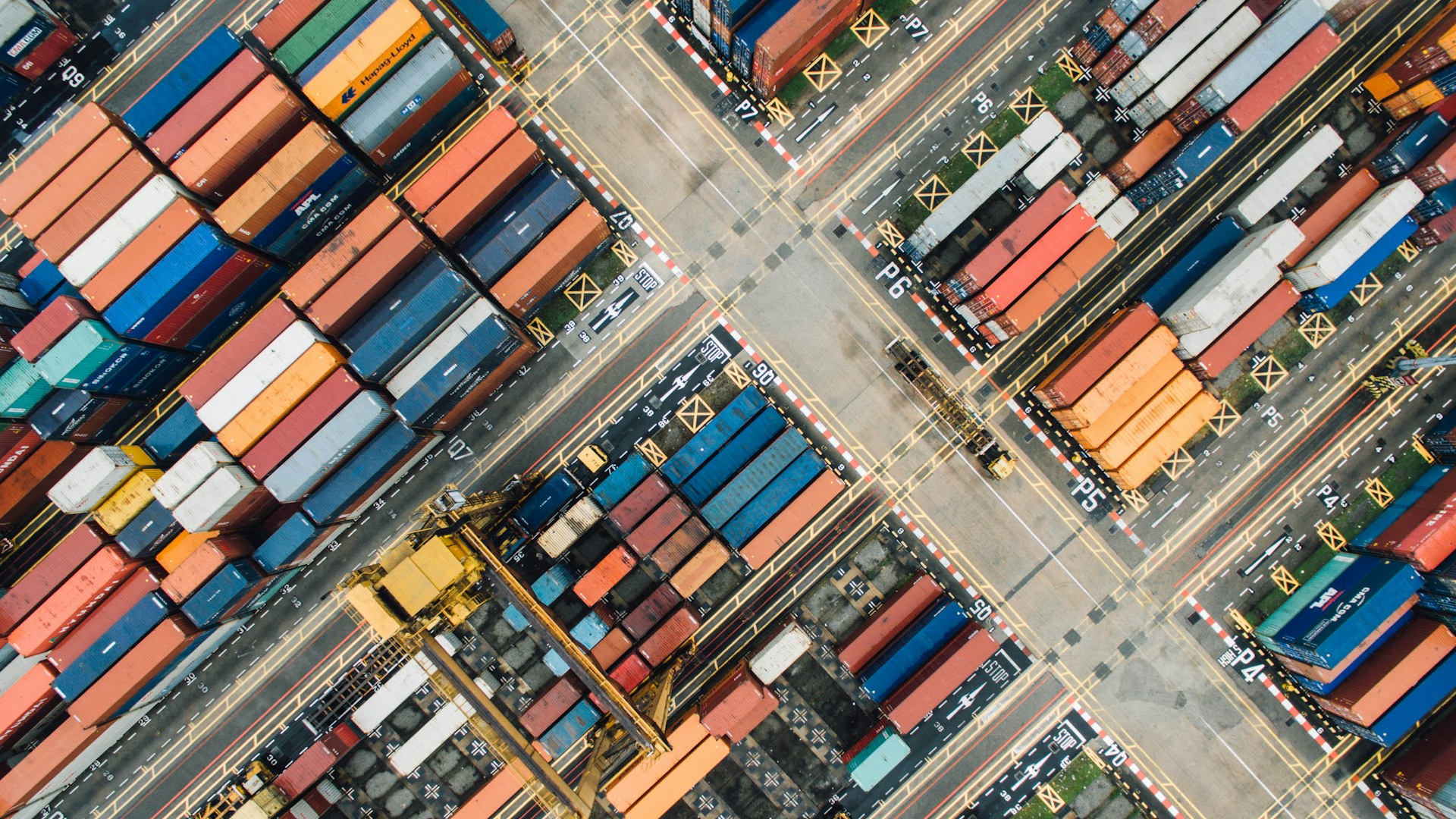 Aerial view of a container port with rows of colourful shipping containers