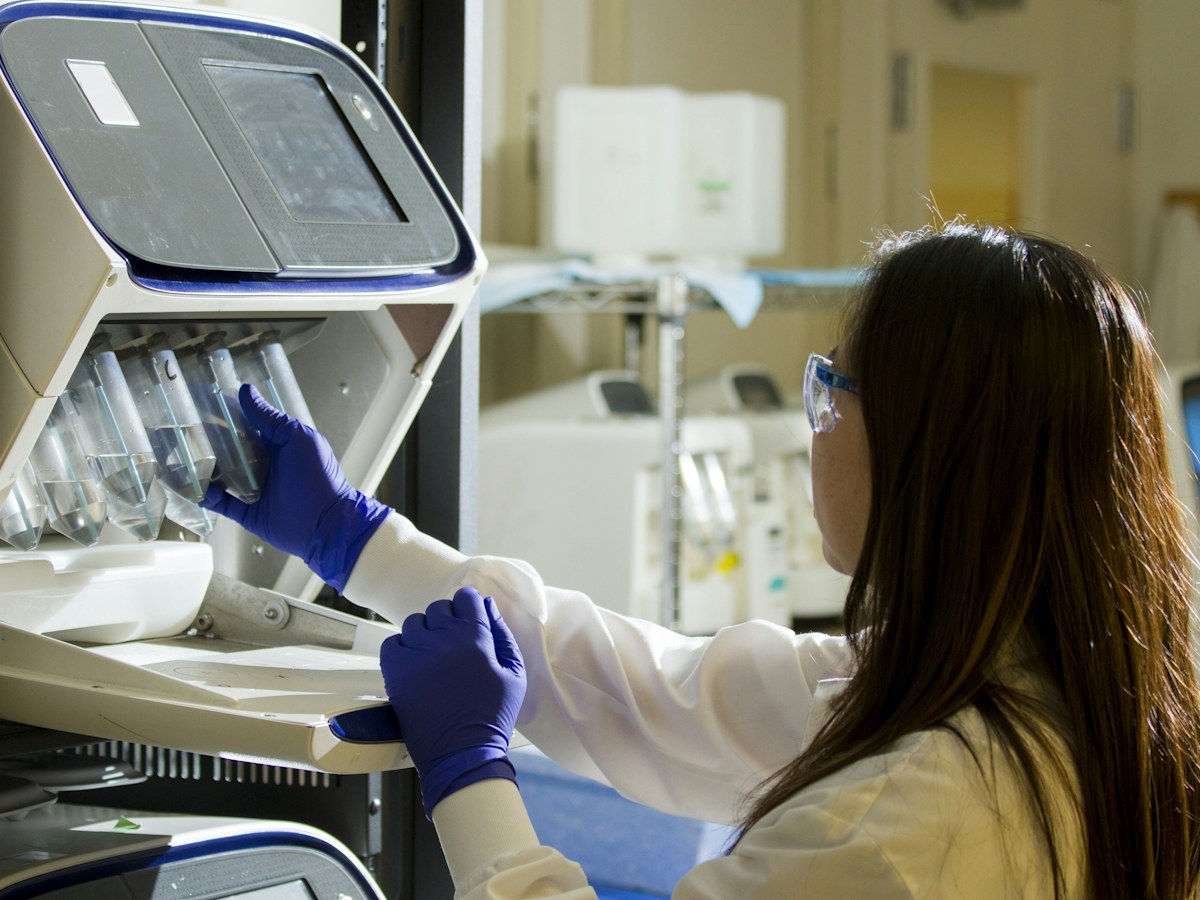 Laboratory scientist holding test tubes with samples